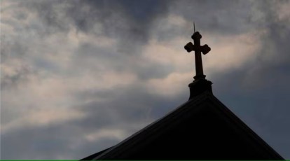 Premium Photo  A man stands in front of a cross on a church