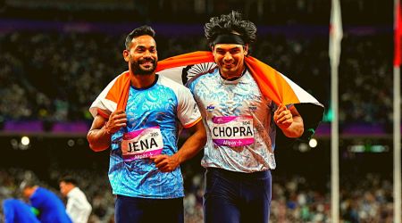 India's Neeraj Chopra (R) and Kishore Kumar Jena wave the national flag after securing gold and silver medal respectively in the Men's Javelin Throw Final event at the 19th Asian Games, in Hangzhou, China, Wednesday, Oct. 4, 2023. (PTI Photo