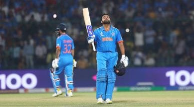 India's captain Rohit Sharma looks skywards as he celebrates his century during the ICC Men's Cricket World Cup match against Afghanistan. (Express Photo by Abhinav Saha)