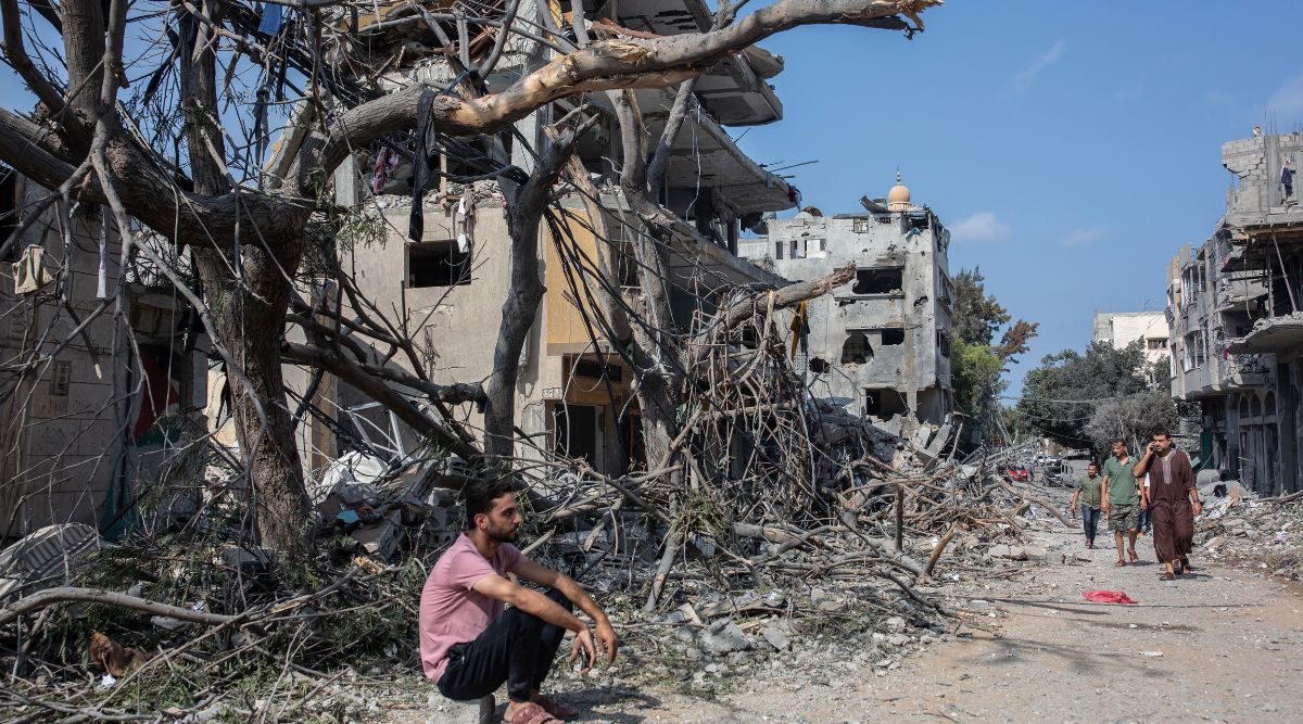 Residents evacuate their homes after a night of Israeli airstrikes and shelling in the Karama district north of Gaza City, Oct. 11, 2023. (Samar Abu Elouf/The New York Times) A boy carries salvaged belongings from the wreckage of his family’s home, which was damaged in an Israeli airstrike on Khan Younis in Gaza on Wednesday, Oct. 11, 2023. Israel heavily bombarded targets in Gaza for a fifth day on Wednesday as Israelis and Palestinians braced for a possible escalation of the war with the Hamas militant group. (Yousef Masoud/The New York Times) A body pulled from the rubble of a building following Israeli airstrikes on the Tel al-Hawa neighborhood of Gaza City is placed into a waiting ambulance on Tuesday, Oct. 10, 2023. (Samar Abu Elouf/The New York Times) Men search for survivors in the rubble of a home that was destroyed in an Israeli airstrike on Khan Younis in Gaza on Wednesday, Oct. 11, 2023. Israel heavily bombarded targets in Gaza for a fifth day on Wednesday as Israelis and Palestinians braced for a possible escalation of the war with the Hamas militant group. (Yousef Masoud/The New York Times) An injured woman outside Al Shifa Hospital in Gaza City on Thursday, Oct. 12, 2023. Staff members are scrambling to treat the wounded, who are crammed into corridors that are also filled with people who fled their homes amid Israeli airstrikes. (Samar Abu Elouf/The New York Times) People look for survivors in the wreckage of a house destroyed in an Israeli airstrike on Khan Younis in Gaza on Wednesday, Oct. 11, 2023. Israel heavily bombarded targets in Gaza for a fifth day on Wednesday as Israelis and Palestinians braced for a possible escalation of the war with the Hamas militant group. (Yousef Masoud/The New York Times) A woman watches from an apartment in Gaza City as smoke rises from Israeli airstrikes on Wednesday, Oct. 11, 2023. Israel heavily bombarded targets in Gaza for a fifth day on Wednesday as Israelis and Palestinians braced for a possible escalation of the war with the Hamas militant group. (Samar Abu Elouf/The New York Times) Local residents gather to search for survivors after a house was hit by an Israeli airstrike in Khan Younis, in southern Gaza, on Thursday, Oct. 12, 2023. The Israeli military says its troops are preparing “for the next stage of the war” on Thursday, signaling that a ground invasion of Gaza could be coming. (Yousef Masoud/The New York Times) Local residents view the destruction following Israeli airstrikes on the Al-Rimal neighborhood of Gaza City on Tuesday.