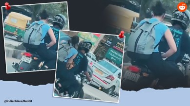 Woman uses laptop while riding pillion on motorcycle without a helmet in Bengaluru