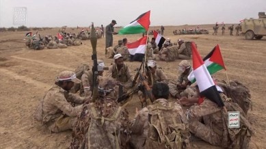Houthi fighters gather during a military manoeuvre near Sanaa