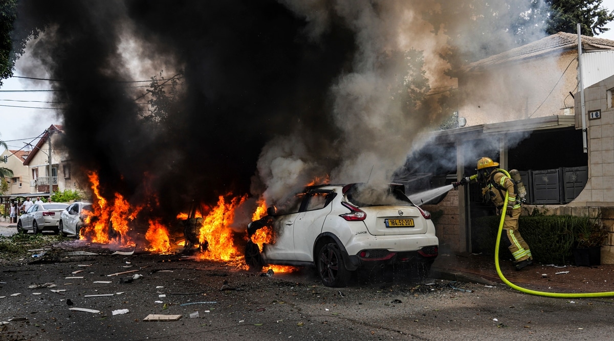 Israeli firefighters extinguish fire at a site struck by a rocket fired from the Gaza Strip, in Ashkelon, southern Israel, Monday, Oct. 9, 2023. (AP Photo/Tsafrir Abayov)