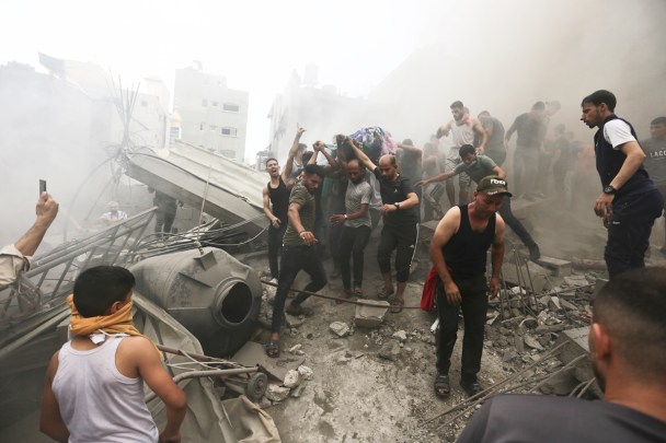 FILE - Palestinians remove a dead body from the rubble of a building after an Israeli airstrike on the Jebaliya refugee camp, Gaza Strip, Monday, Oct. 9, 2023. (AP Photo/Ramez Mahmoud, File)