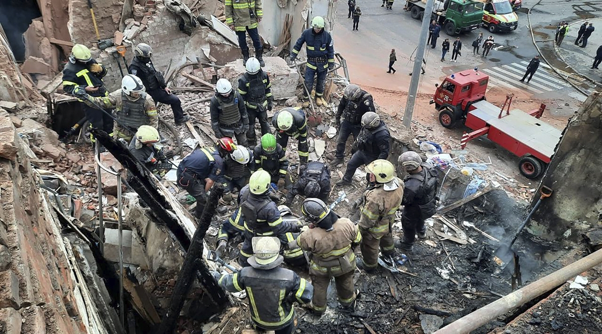 Emergency workers search for victims of the Russian rocket attack that damaged a multi-storey building in central Kharkiv, Oct. 6, 2023. (Ukrainian Police Press Office via AP)