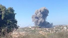 Plumes of smoke rise in the aftermath of an attack, as seen from Rmaych