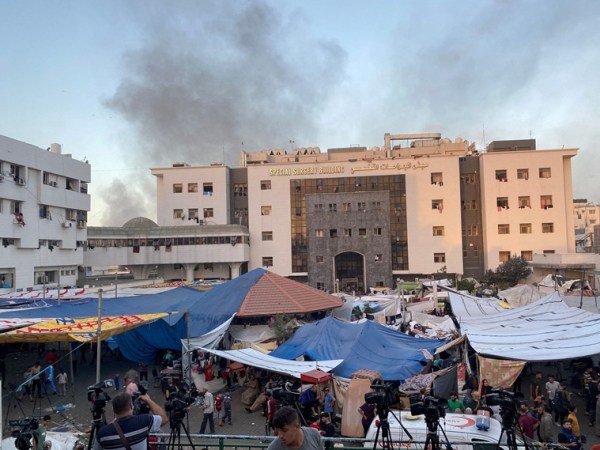 Smoke rises as displaced Palestinians take shelter at Al Shifa hospital, amid the ongoing conflict between Hamas and Israel, in Gaza City, November 8, 20