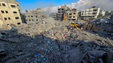 Palestinians gather at the site of Israeli strikes on houses in Jabalia refugee camp
