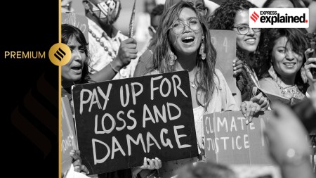 Mitzi Jonelle Tan, of the Philippines, center, participates in a Fridays for Future protest calling for money for climate action at the COP27 U.N. Climate Summit, Nov. 11, 2022, in Sharm el-Sheikh, Egypt.