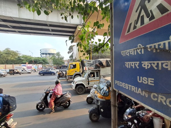 Even as a board instructs pedestsrians to use Zebra Crossing, vehicle leave no room for them to use it. The image from Viman Nagar Chowk on Pune-Ahmednagar Road. (Express Photo by Atikh Rashid)