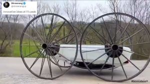 Man puts four 10-ft buggy wheels on a Tesla and drives it.