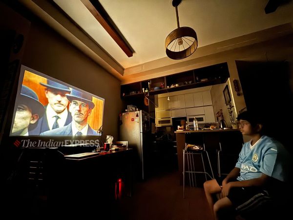 A child watching a series on an optoma projector