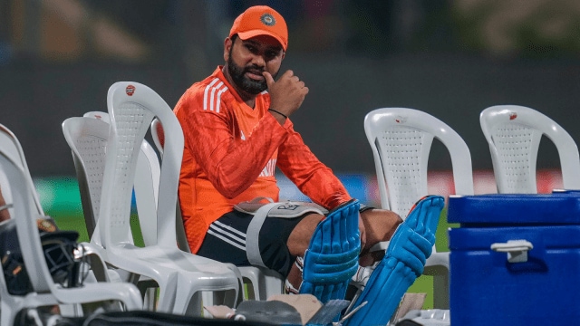 Rohit Sharma handing over one of his shoes to a kid.