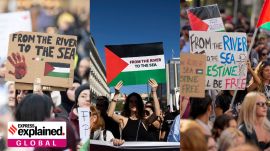 Women carrying placards with the slogan 'Palestine will be free from the river to the sea' during pro-Palestine protests.