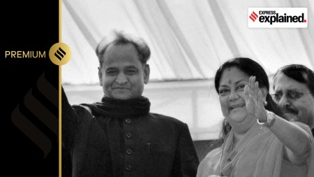 Newly sworn-in Rajasthan Chief Minister Vasundhara Raje with her predecessor Ashok Gehlot waves to crowd during a ceremony in Jaipur in 2013.