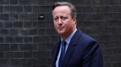 Former British Prime Minister David Cameron walks outside 10 Downing Street in London