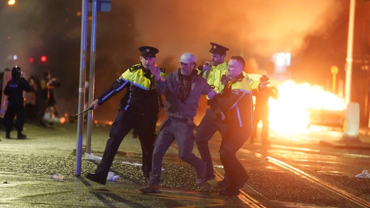 Irish police officers apprehend a man after a demonstration near the scene of an attack in Dublin city center, Thursday Nov. 23, 2023. A 5-year-old girl is receiving emergency medical treatment in a Dublin hospital following an attack on Thursday that involved a knife. A woman and two other children were injured. Irish police said they weren't treating the case as terror-related, and that a man in his 50s, who was also hospitalized with serious injuries, is a “person of interest.” (Brian Lawless/PA via AP)