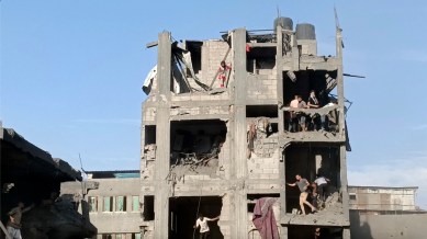 In this frame grab from video, Palestinians are seen inside a heavily damaged apartment building following Israeli airstrikes at the Jabaliya refugee camp on Gaza City’s outskirts, Tuesday, Oct. 31, 2023. (Fadi Majed via AP)
