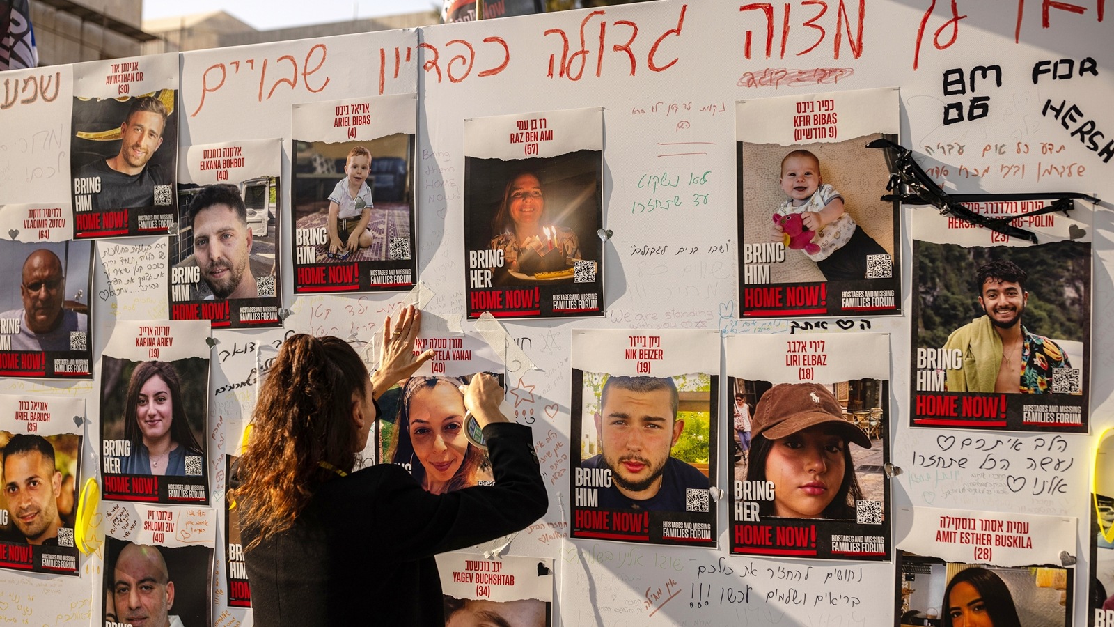 Photos of Israeli citizens who are being held hostage in Gaza are displayed in Tel Aviv, Israel on Oct. 24, 2023. When it was all said and done, the deal to release some of the hostages held by Hamas came down to two critical phone calls ultimately forcing each side to make a tough concession. (Tamir Kalifa/The New York Times)