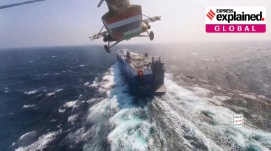 Houthi military helicopter flies over the Galaxy Leader cargo ship in the Red Sea in this photo released November 20, 2023.