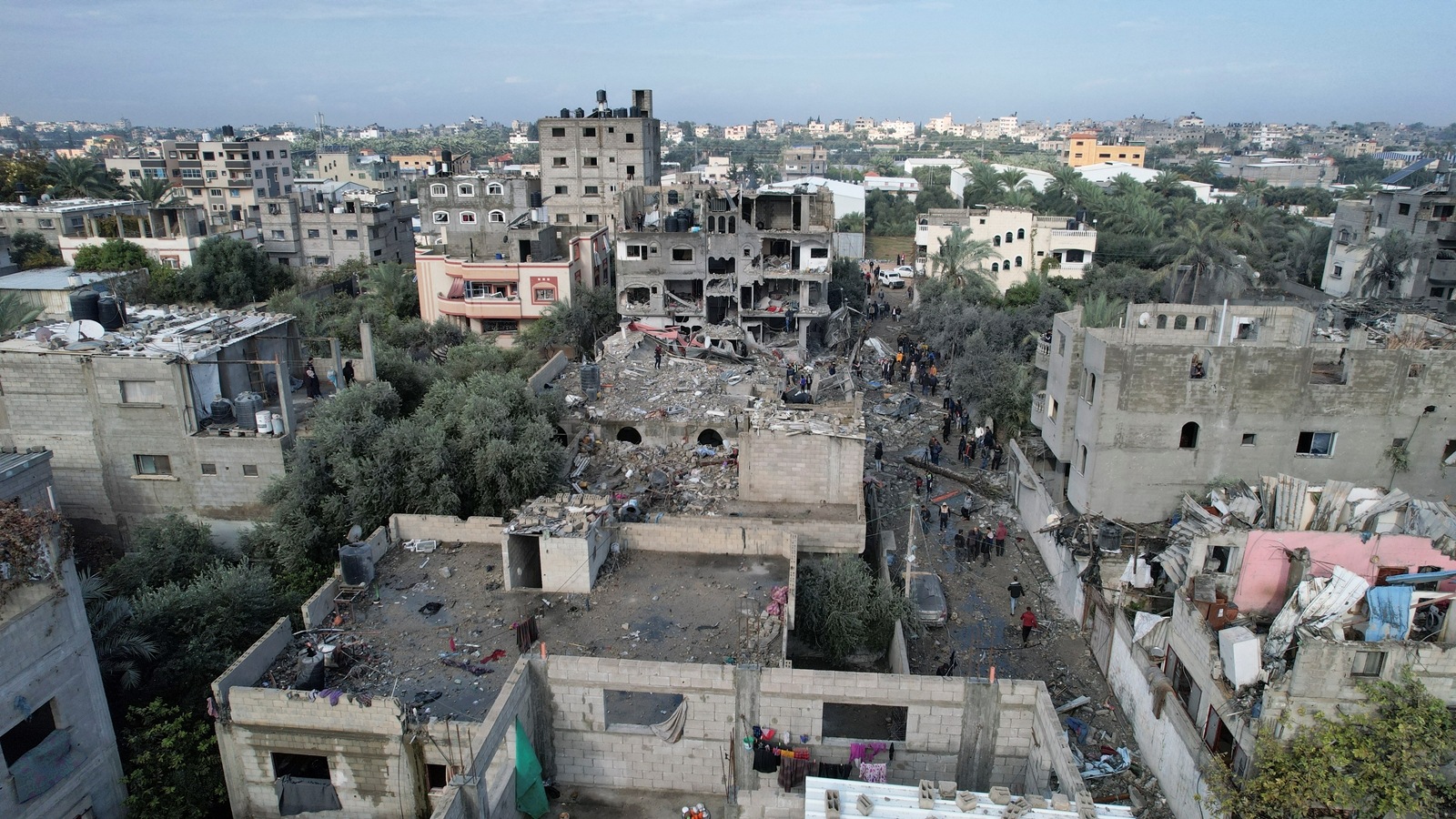 Palestinians gather at the site of Israeli strikes on houses, at the Maghazi camp in the central Gaza Strip