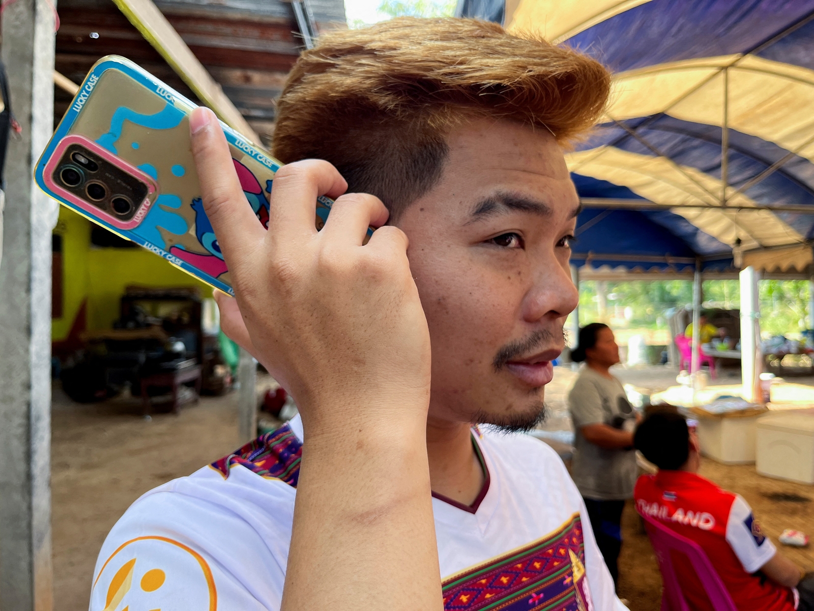 Anucha Angkaew, a Thai farm worker who was abducted by Hamas while working in Israel in October and spent over 50 days in captivity in Gaza, speaks on the phone at his family home in Don Pila village in Udon Thani province, Thailand December 6, 2023. REUTERS/Devjyot Ghoshal