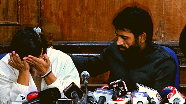 Tokyo Olympics bronze medallist Bajrang Punia consoles Vinesh Phogat at a press conference on Thursday in New Delhi. (Express photo by Abhinav Saha)