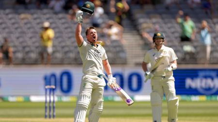David Warner of Australia celebrates on reaching a century during play on the first day of the first cricket test between Australia and Pakistan in Perth, Australia. (AP)