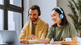 Students happily taking online AI course on their laptop
