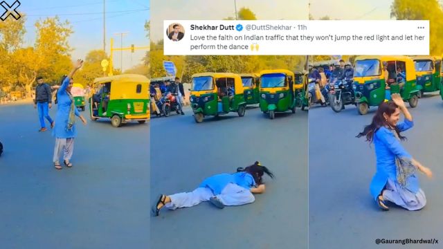 Girl dances on road during a traffic halt.