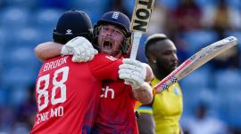 England's batsmen Harry Brook (left), and Phil Salt celebrate defeating West Indies' by seven wickets with one ball remaining during the third T20 cricket match at National Cricket Stadium in Saint George's, Grenada (AP)
