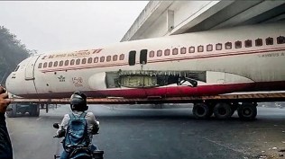 aeroplane stuck under bridge