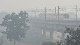 A metro treads amid dense smog