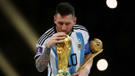 Argentina's Lionel Messi kisses the World Cup trophy after receiving the Golden Ball award as he celebrates after winning the World Cup REUTERS