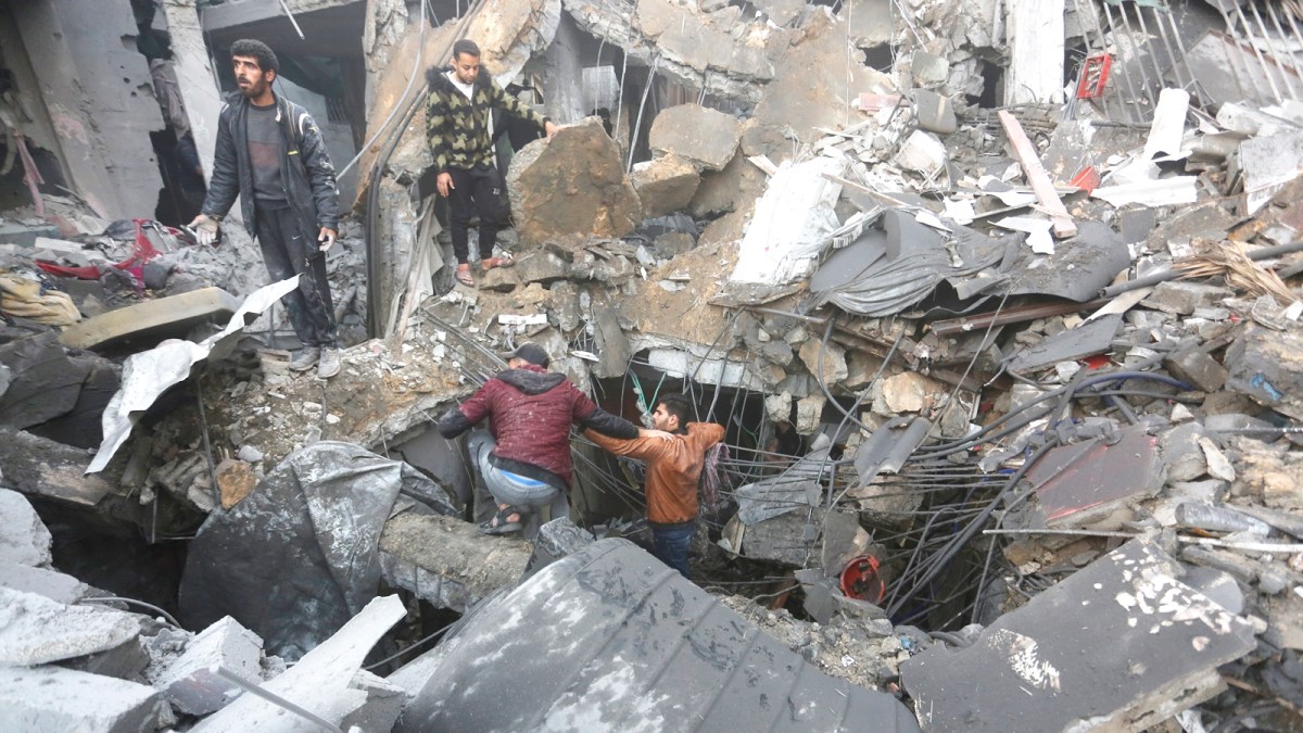 Palestinians look for survivors of the Israeli bombardment of the Gaza Strip in Rafah on Tuesday, Dec. 12, 2023. (AP Photo/Hatem Ali)