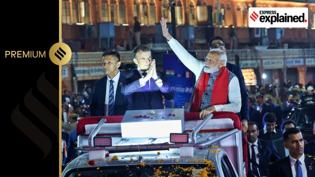 Prime Minister Narendra Modi and French President Emmanuel Macron greet people during a roadshow in Jaipur, India, January 25, 2024.