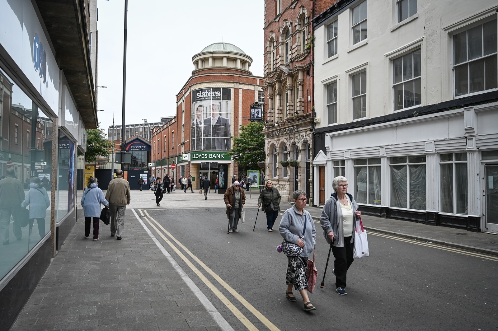 People walk through the center of Hull, England on a busy weekday on May 31, 2023. An “integrated care center” brings doctors, physiotherapists, social workers, and pharmacists under one roof. It won’t solve Britain’s underlying social care crisis — but it could help. (Mary Turner/The New York Times)