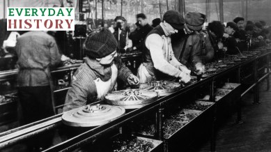 Workers on the first moving assembly line put together magnetos and flywheels for Ford in 1913.