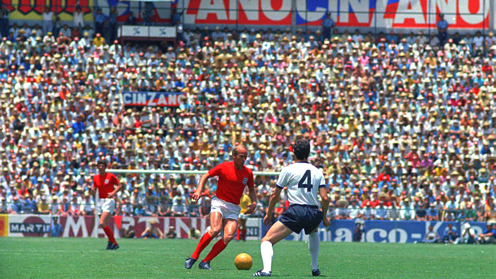 England's Bobby Charlton, centre, and West Germany's captain Franz Beckenbauer, right, challenge for the ball during the quarter finals of the World Cup, in Leon, Mexico, June 14, 1970