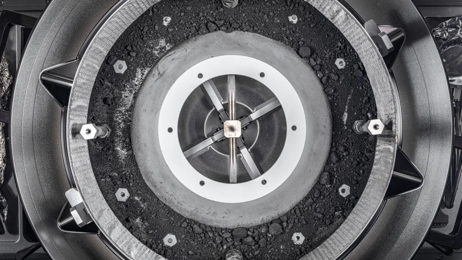 A top-down view of the asteroid Bennu sample and its container.