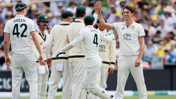 Australia's Pat Cummins, right, is congratulated by teammates after bowling out West Indies' Kraigg Brathwaite on the first day of their cricket test match in Adelaide, Australia, Wednesday. (AP)