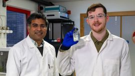 Sudhagar Pitchaimuthu (left) and PhD student Michael Walsh with a sample of whisky distillery wastewater.