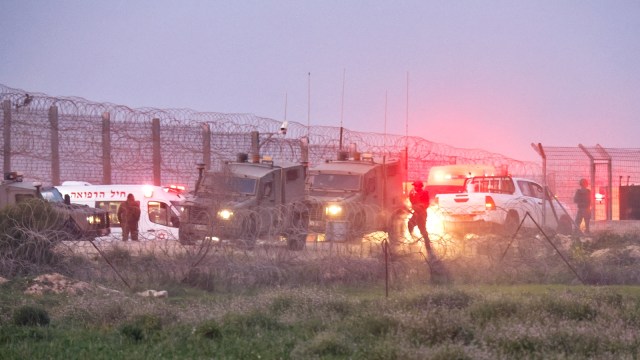 Israeli soldiers walk next to military vehicles and ambulances, as the conflict continues between Israel and the Palestinian Islamist group Hamas, near the fence on the Israeli border with Gaza, Israel, January 22, 2024. (Reuters)