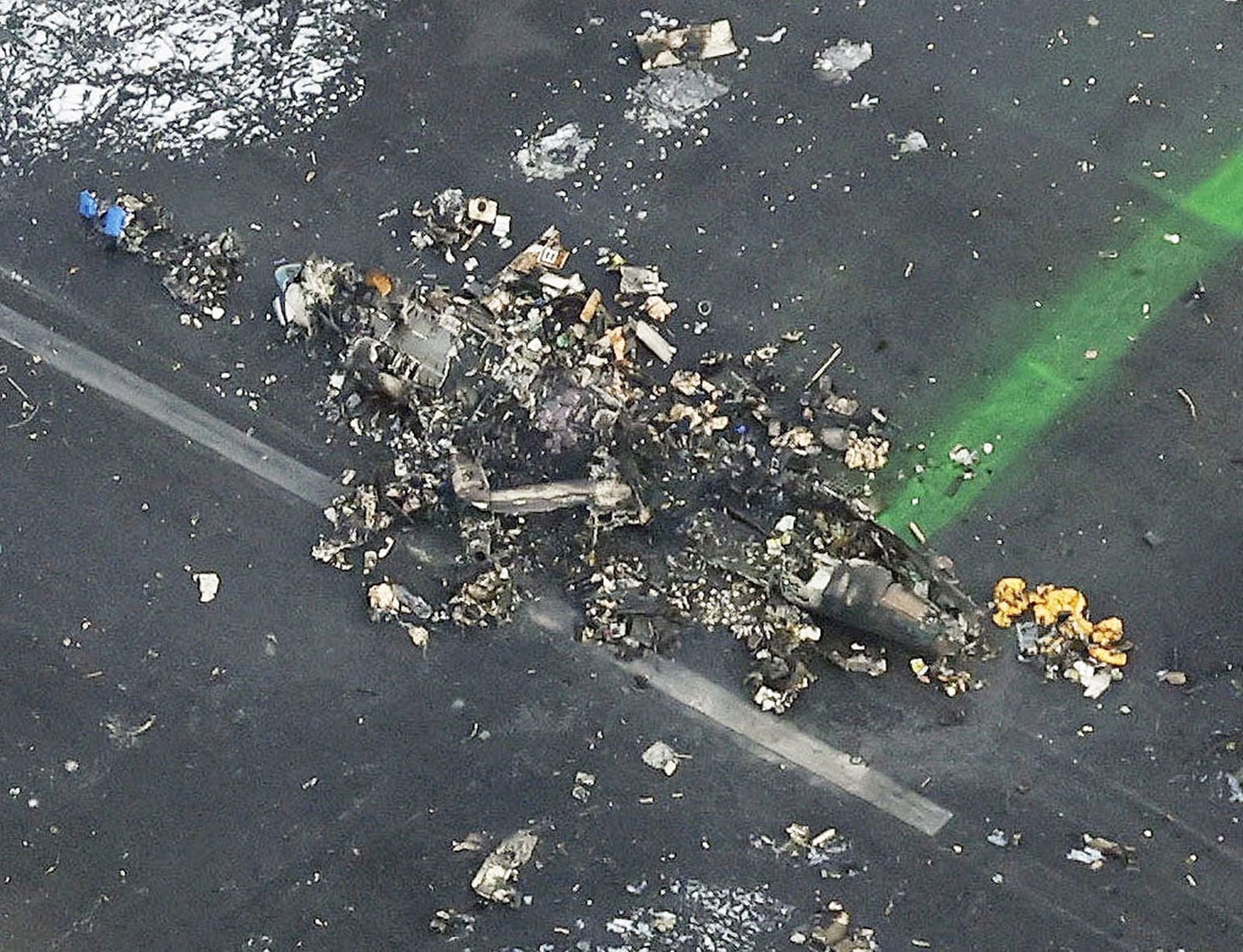 An aerial view shows burnt Japan Coast Guard aircraft after a collision with Japan Airlines' (JAL) Airbus A350 plane at Haneda International Airport in Tokyo, Japan January 3, 2024, in this photo taken by Kyodo. Mandatory credit Kyodo/via REUTERS ATTENTION EDITORS - THIS IMAGE HAS BEEN SUPPLIED BY A THIRD PARTY. MANDATORY CREDIT. JAPAN OUT. NO COMMERCIAL OR EDITORIAL SALES IN JAPAN.