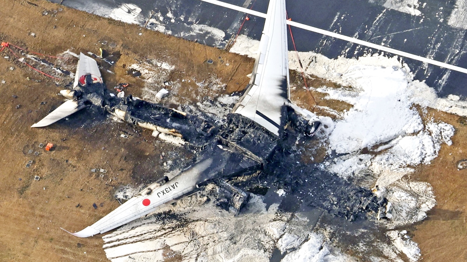 An aerial view shows burnt Japan Airlines' (JAL) Airbus A350 plane after a collision with a Japan Coast Guard aircraft at Haneda International Airport in Tokyo, Japan January 3, 2024, in this photo taken by Kyodo. Mandatory credit Kyodo/via REUTERS ATTENTION EDITORS - THIS IMAGE HAS BEEN SUPPLIED BY A THIRD PARTY. MANDATORY CREDIT. JAPAN OUT. NO COMMERCIAL OR EDITORIAL SALES IN JAPAN. TPX IMAGES OF THE DAY