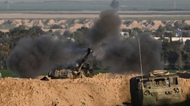 An Israeli mobile artillery unit fires towards Gaza