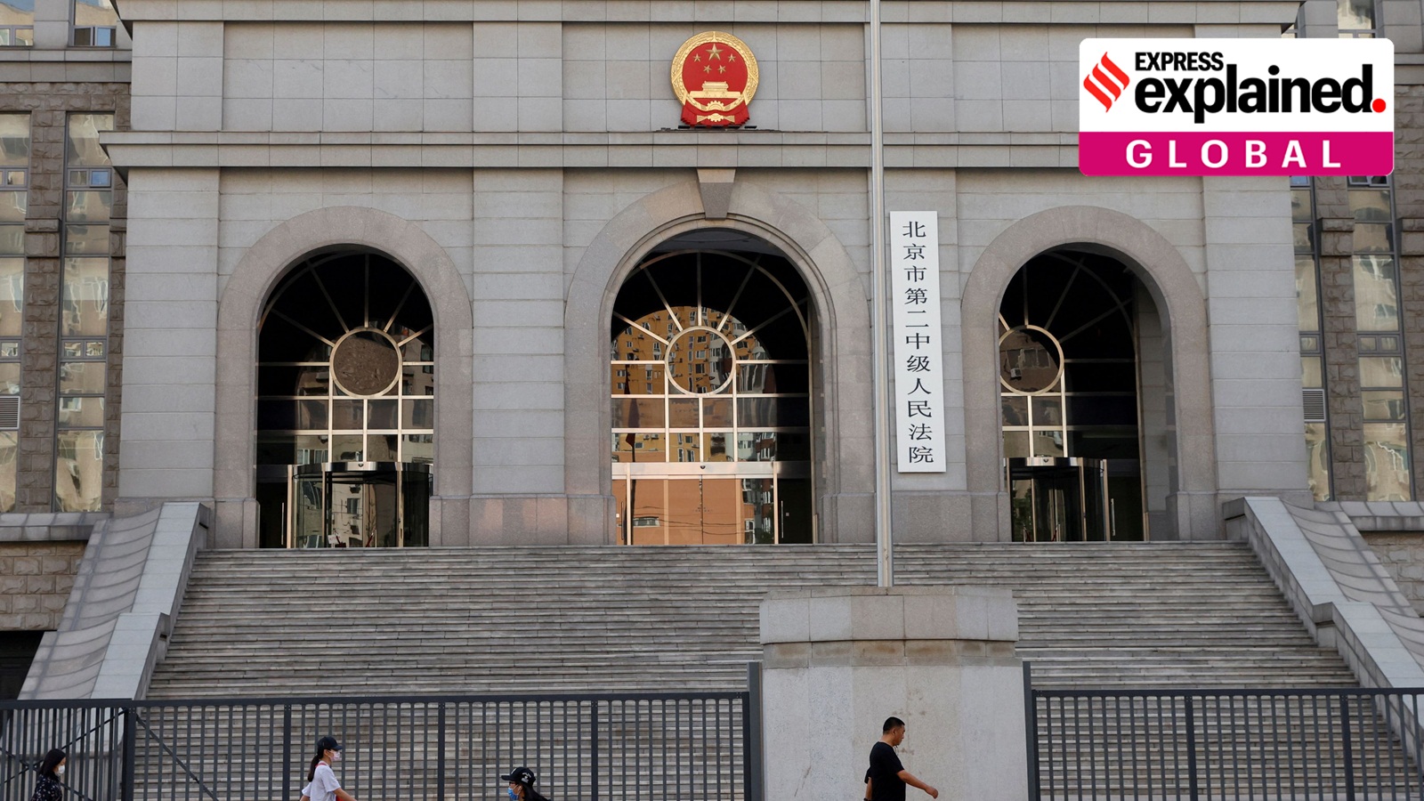 People walk past one of the entrances of Beijing No. 2 Intermediate People's Court where Australian writer Yang Hengjun was expected to face trial on espionage charges, in Beijing, China May 27, 2021.