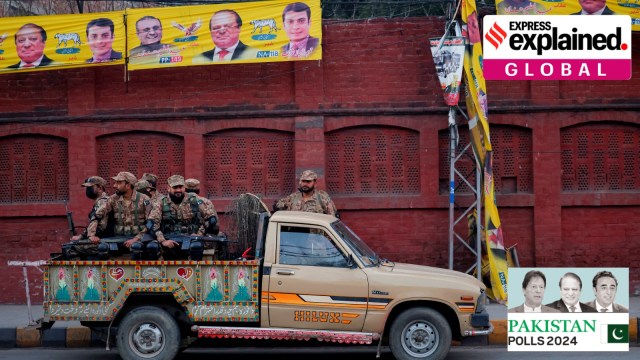 Army personnel sit in a vehicle near a polling station on the day of the general election, in Lahore, Pakistan February 8, 2024.