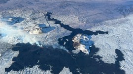 An arial view of a volcano spewing lava and smoke as it erupts in Reykjanes Peninsula in Iceland