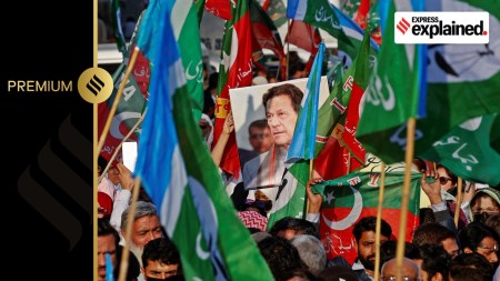 A portrait of the former Prime Minister Imran Khan is seen amid flags of Pakistan Tehreek-e-Insaf (PTI) and the religious and political party Jamat-e-Islami (JI) as supporters attend a joint protest demanding free and fair results of the elections, outside the provincial election commission of Pakistan (ECP)in Karachi, Pakistan February 10, 2024.